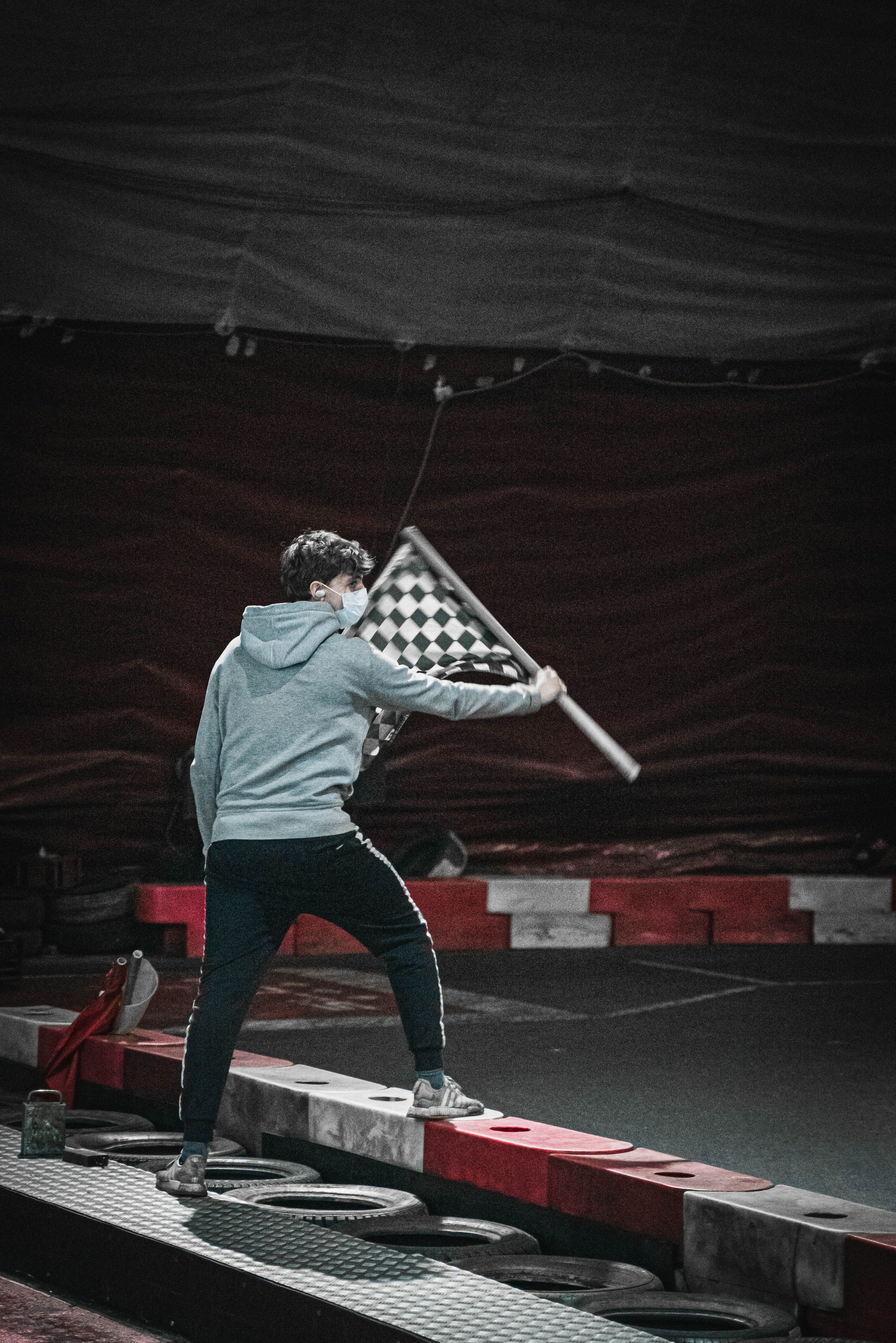 Checkered flag waving over the finish line at a short track